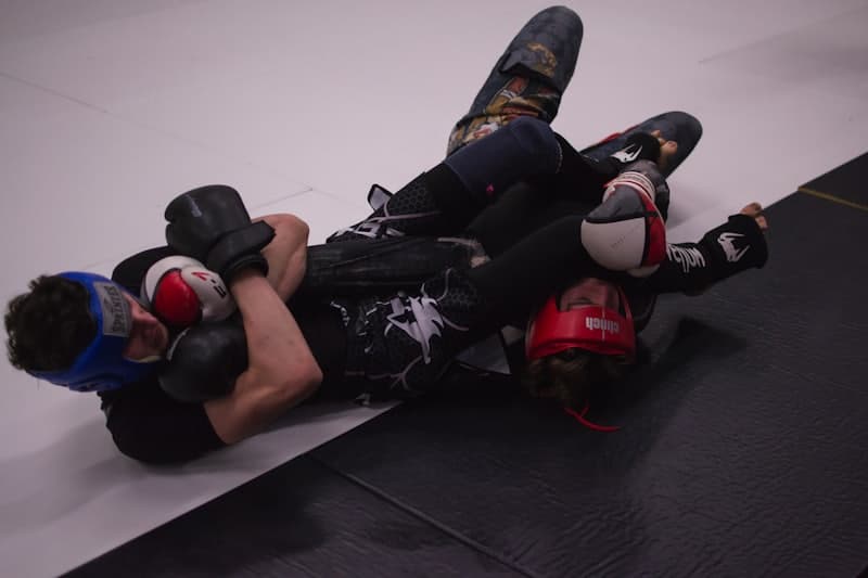 BJJ athletes grappling on the mat