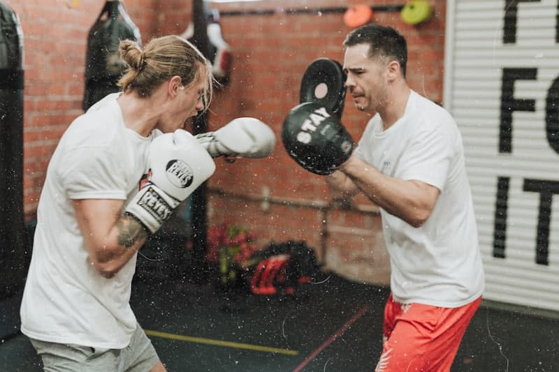 Boxer working the pads with a coach