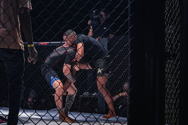MMA fighters grappling in the cage